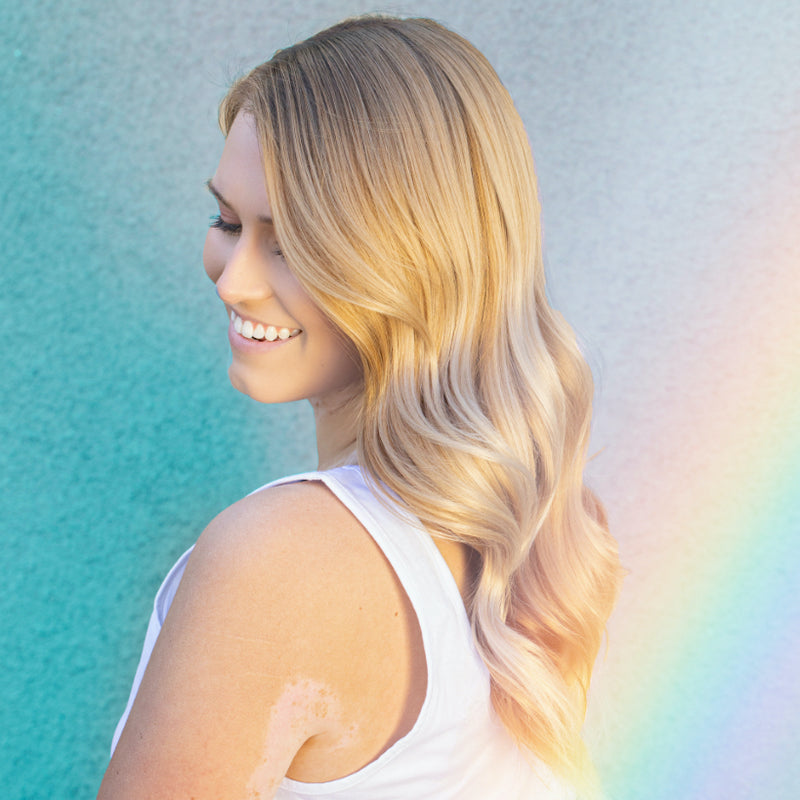 Woman with blonde hair and lens flare to highlight Malibu C hair care