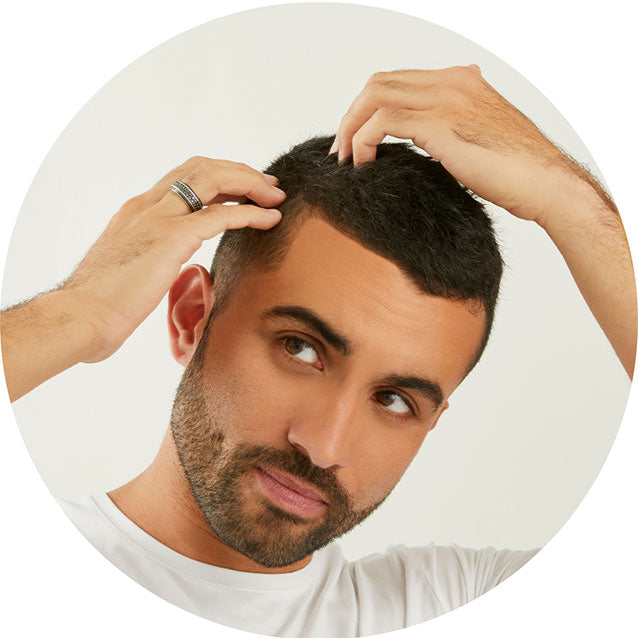 Man looking at scalp to highlight Malibu C Scalp Wellness